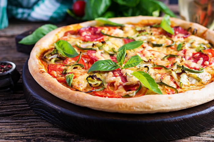 italian pizza with chicken salami zucchini tomatoes herbs