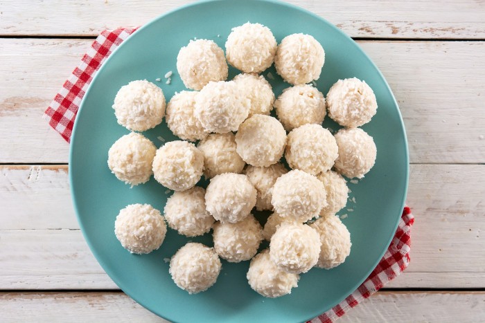 homemade coconut balls white wooden table