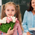 little girl holding bouquet flowers her teacher