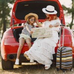 little girl ready go vacations mother with daughter examining map traveling by car with kids