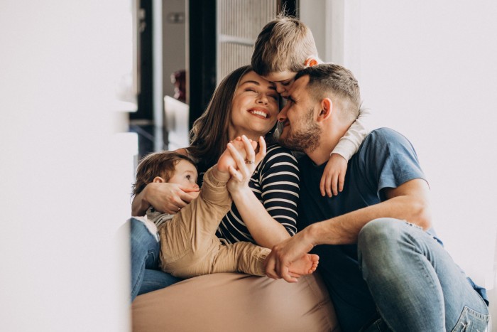 young family with their sons home having fun