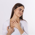 young woman scratching her neck due itching gray background female has itching neck concept allergy symptoms healthcare