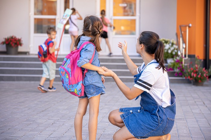 mother accompanies student school happy little girl with caring mom back school