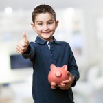 boy with thumg up piggy banck
