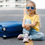 cute little girl with suitcase outdoor
